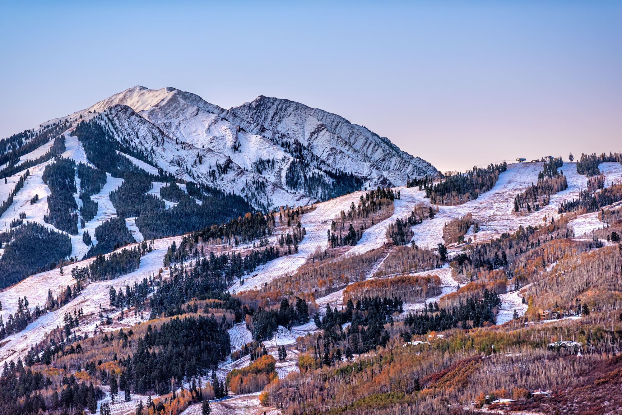 Aerial high angle view of ski resort town city of Aspen, Colorado after winter snow on Buttermilk mountain slopes