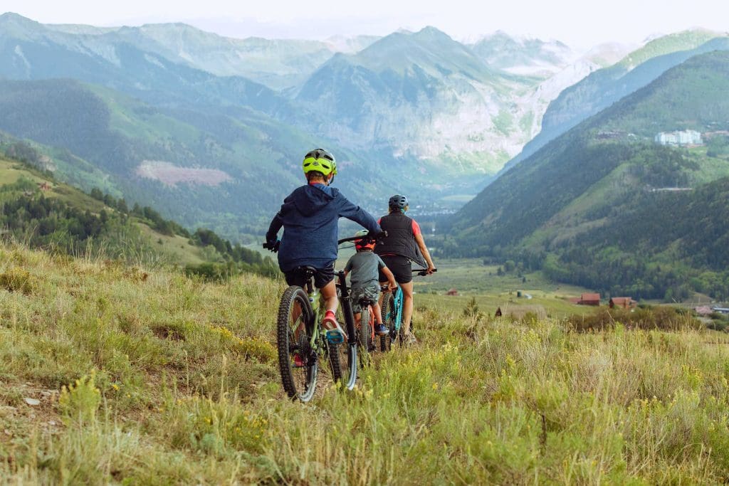 family of 3 mountain biking
