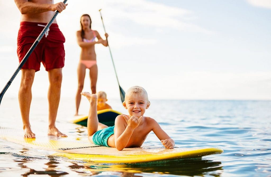 Family of 3 paddle boarding