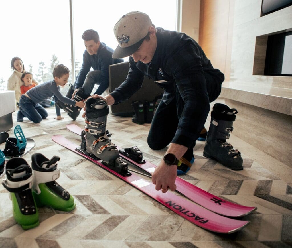 One of our expert fitters providing concierge ski fitting service for a family.