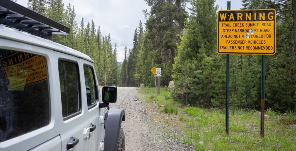 a jeep on the road to Sun Valley with a caution sign.
