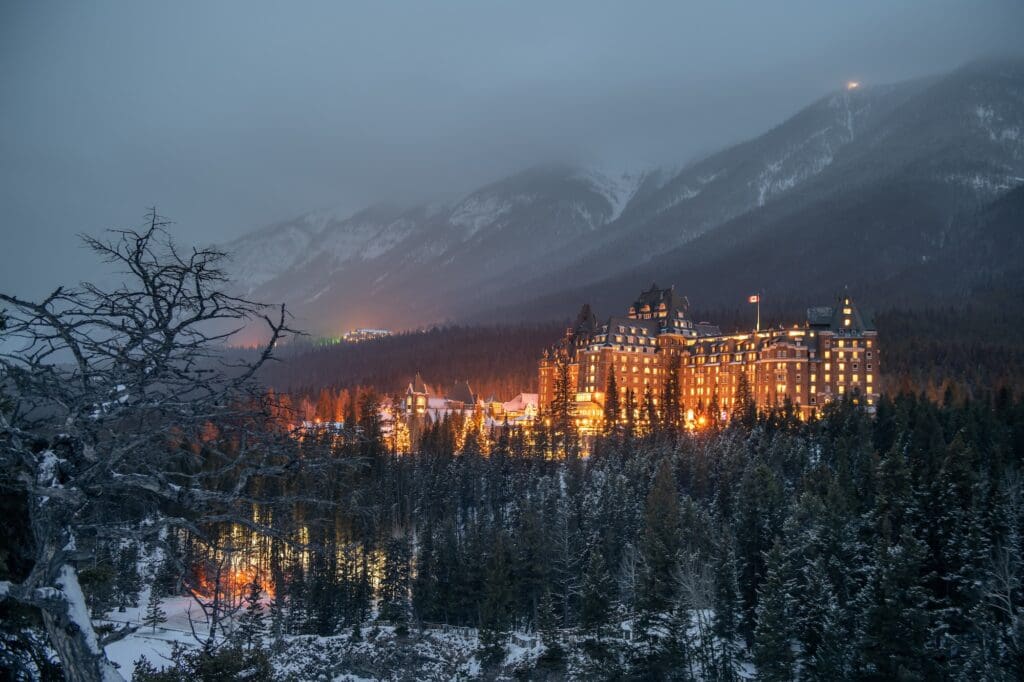 A snowstorm blossoms over the historic Fairmont Springs hotel in Banff.