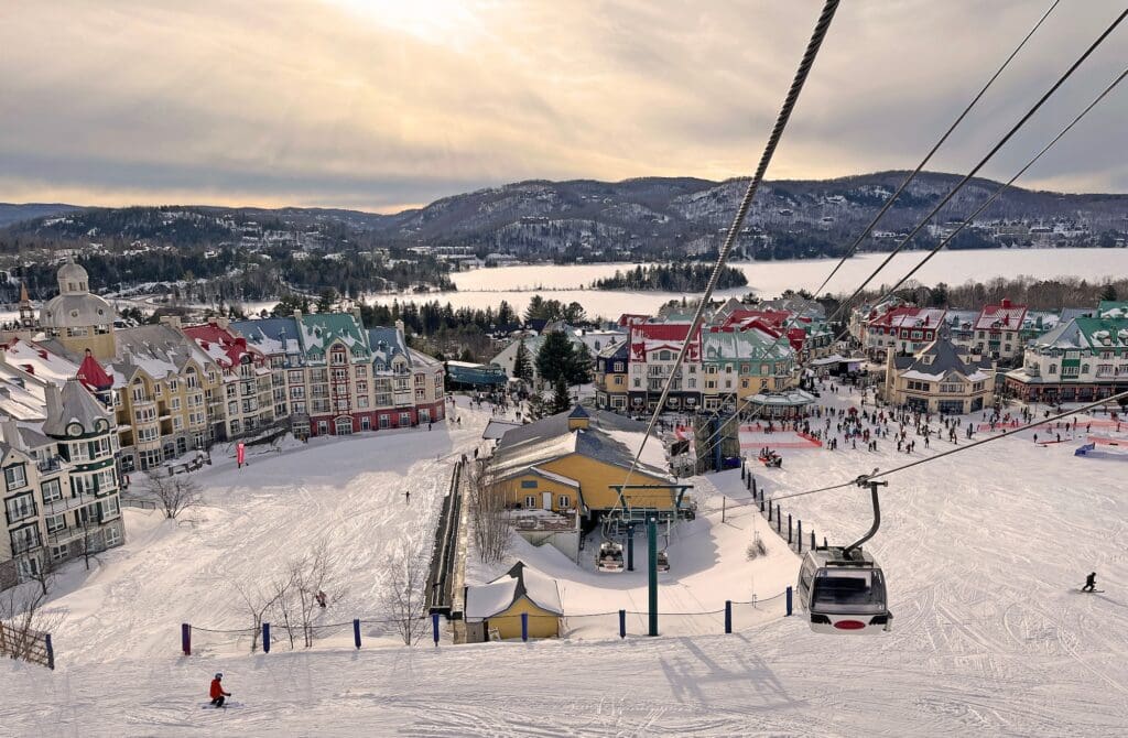 Mont Tremblant village and lake in winter with funiculars in foreground, Quebec, Canada
